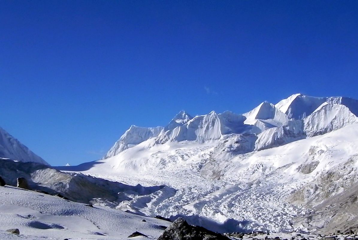 21 Nangpa La, Jobo Rinjang, Lunag IV and Unnamed Mountains From Cho Oyu Intermediate Camp The view to the south from Cho Oyu Intermediate Camp (5434m) includes the Nangpa La pass between Tibet and Nepal on the left with Jobo Rinjang to the right of the pass and Lunag IV the pointed peak in the middle followed by other 6000m peaks.